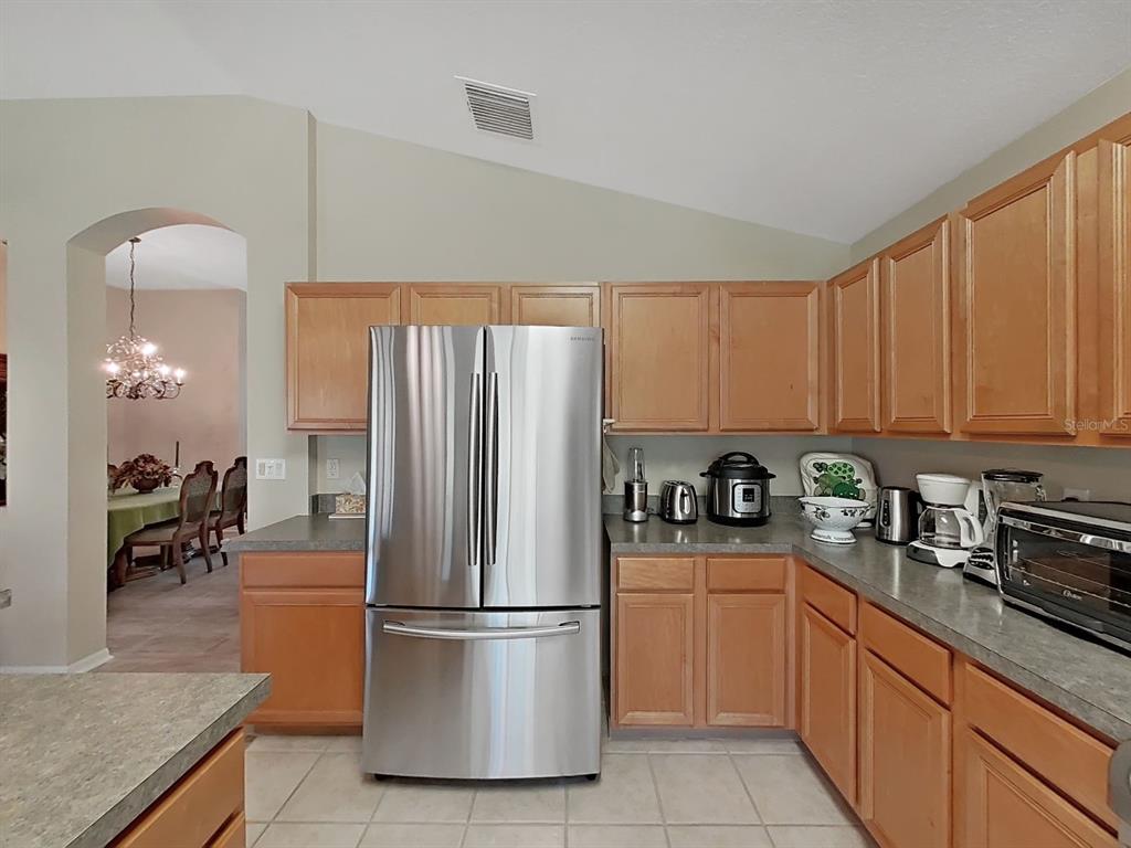 30612 Nickerson Loop Wesley Chapel, FL 33543 - Photo 20 of 47 a kitchen with stainless steel appliances granite countertop a refrigerator sink and cabinets