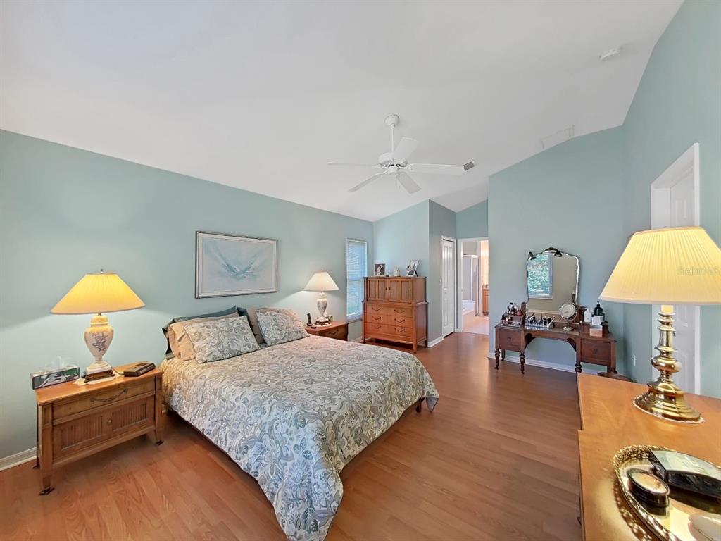 30612 Nickerson Loop Wesley Chapel, FL 33543 - Photo 24 of 47 a bedroom with a bed and wooden floor