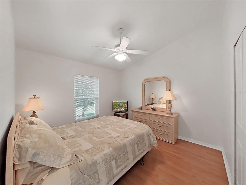 30612 Nickerson Loop Wesley Chapel, FL 33543 - Photo 29 of 47 a bedroom with a bed and a dresser with mirror