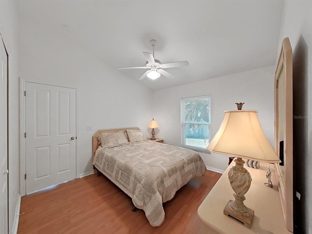 30612 Nickerson Loop Wesley Chapel, FL 33543 - Photo 30 of 47 a bedroom with a bed and a painting on the wall