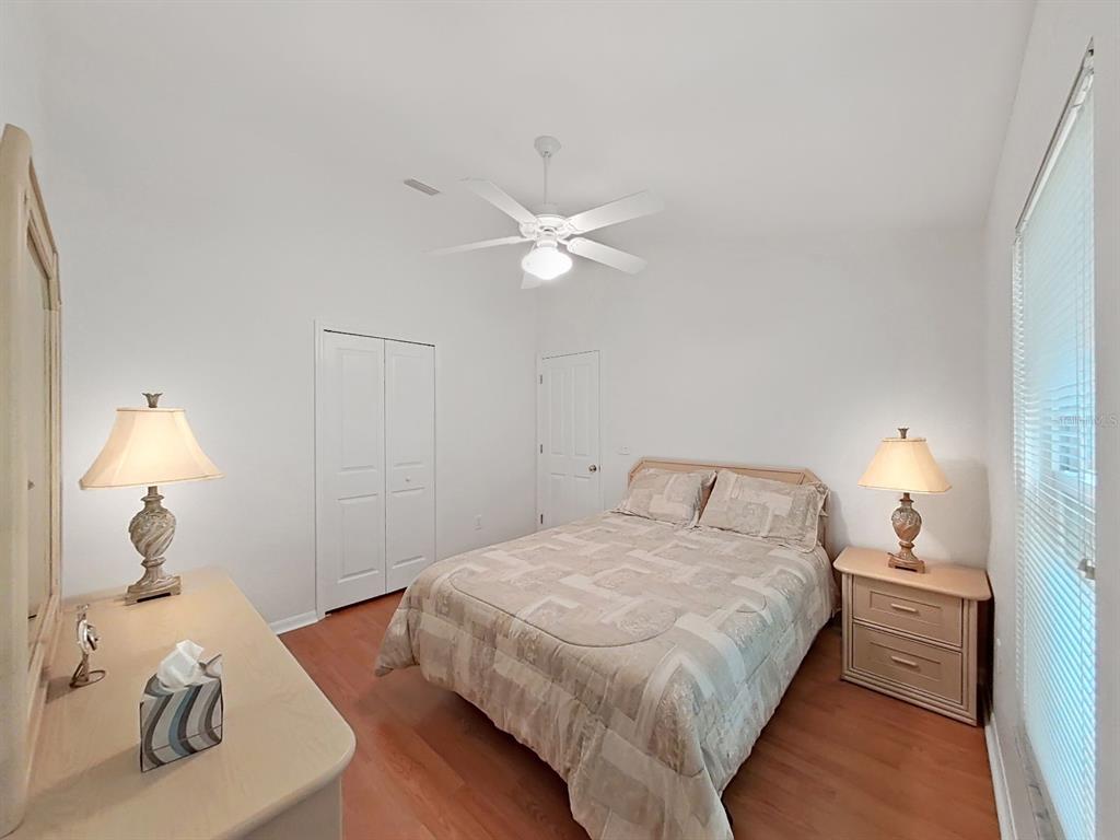 30612 Nickerson Loop Wesley Chapel, FL 33543 - Photo 31 of 47 a bedroom with a bed and a chandelier