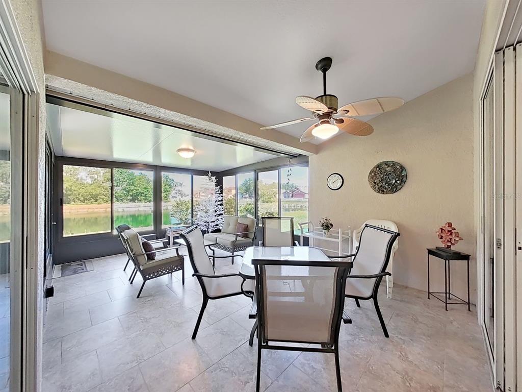 30612 Nickerson Loop Wesley Chapel, FL 33543 - Photo 40 of 47 a dining room with furniture a chandelier and a rug