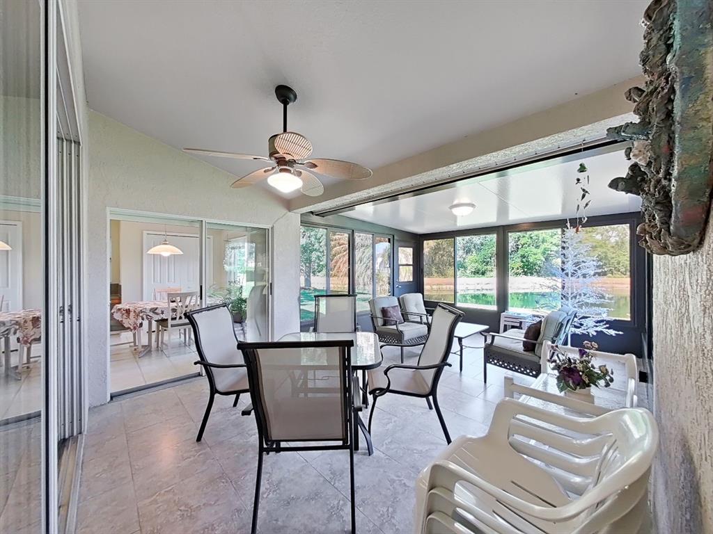 30612 Nickerson Loop Wesley Chapel, FL 33543 - Photo 41 of 47 a view of a dining room with furniture large windows and wooden floor