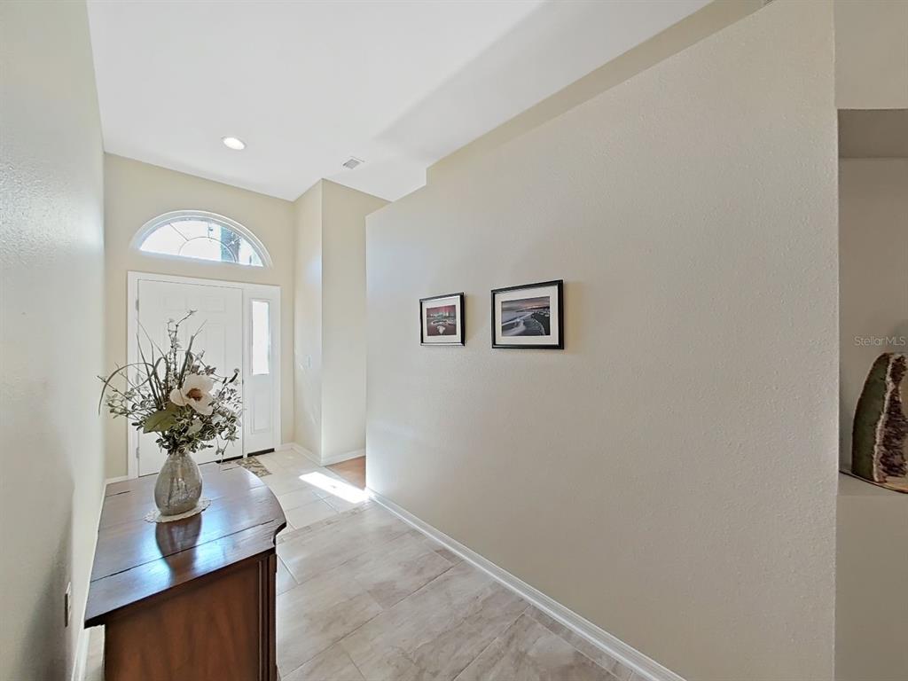 30612 Nickerson Loop Wesley Chapel, FL 33543 - Photo 6 of 47 a view of hall way with mirror and window