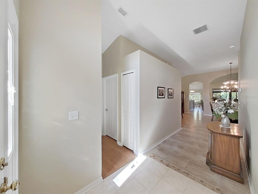 30612 Nickerson Loop Wesley Chapel, FL 33543 - Photo 7 of 47 a view of a hallway with wooden floor and a living room