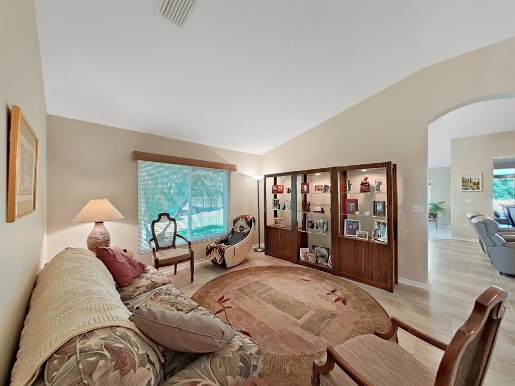 30612 Nickerson Loop Wesley Chapel, FL 33543 - Photo 8 of 47 a living room with furniture and large windows