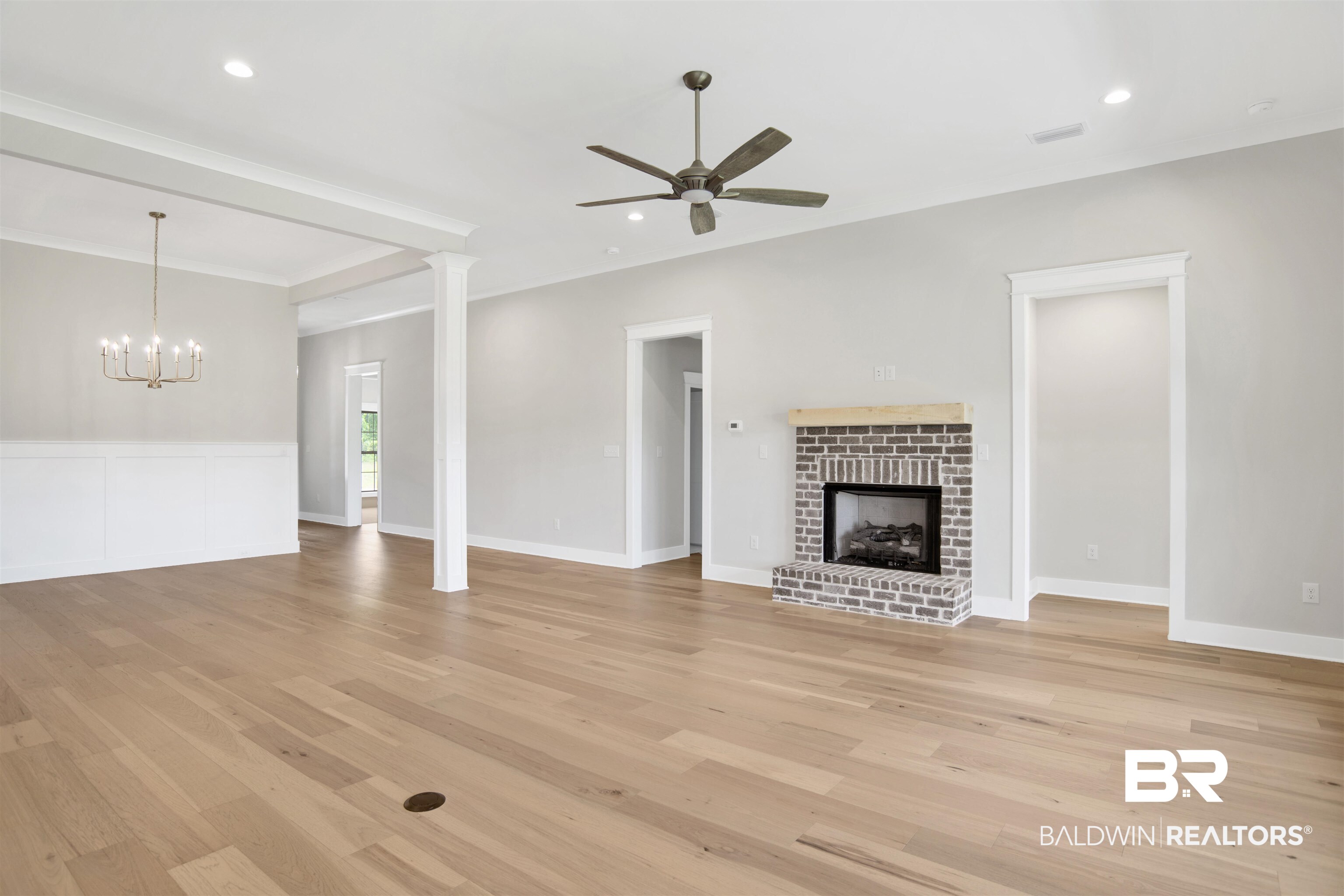 27331 Patch Pl Loop Daphne, AL 36526 - Photo 11 of 62 Unfurnished living room with a brick fireplace, ceiling fan, light wood-type flooring, and suspended lighting