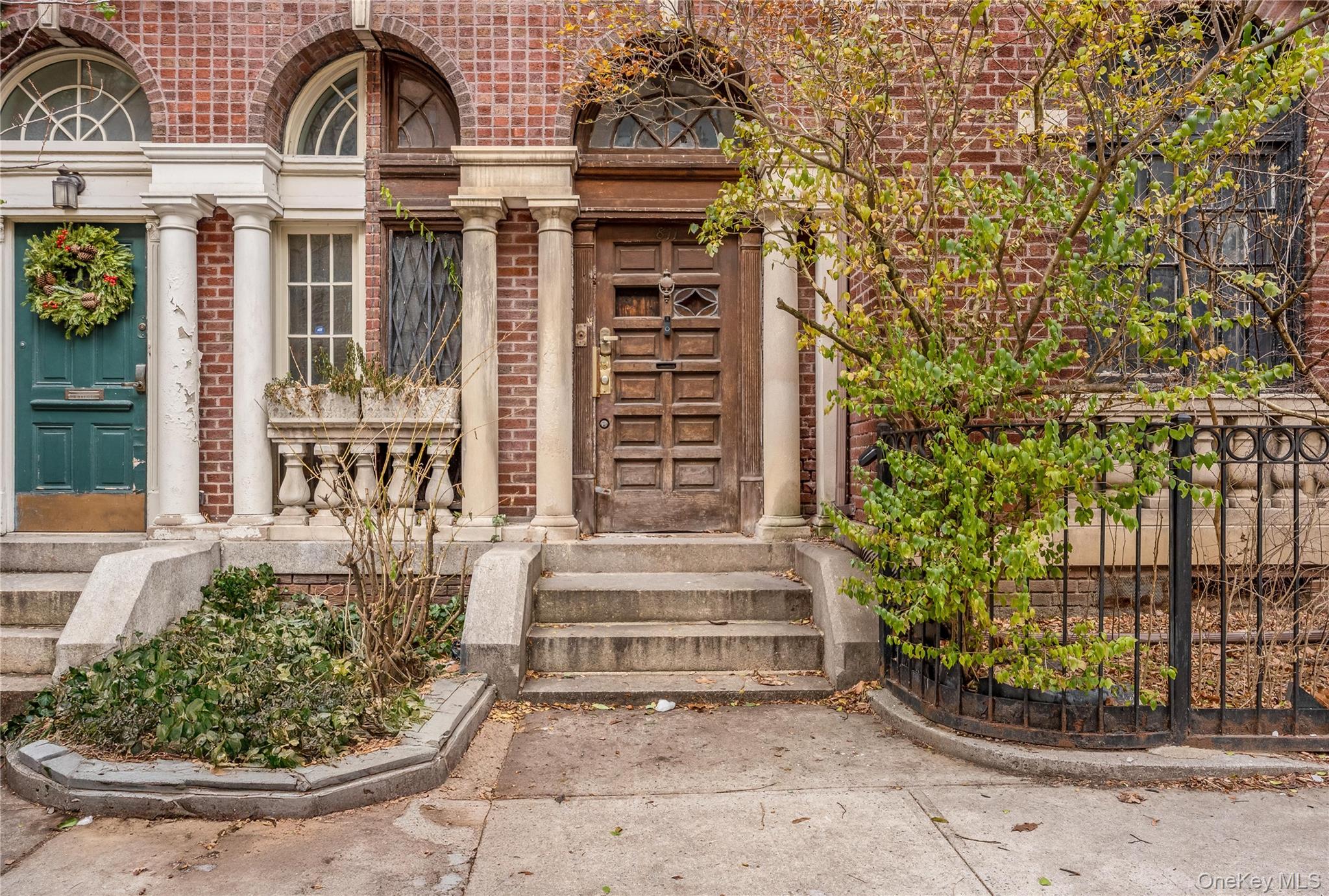 811 Riverside Drive Manhattan, NY 10032 - Photo 2 of 7 a view of a brick house with potted plants and more windows