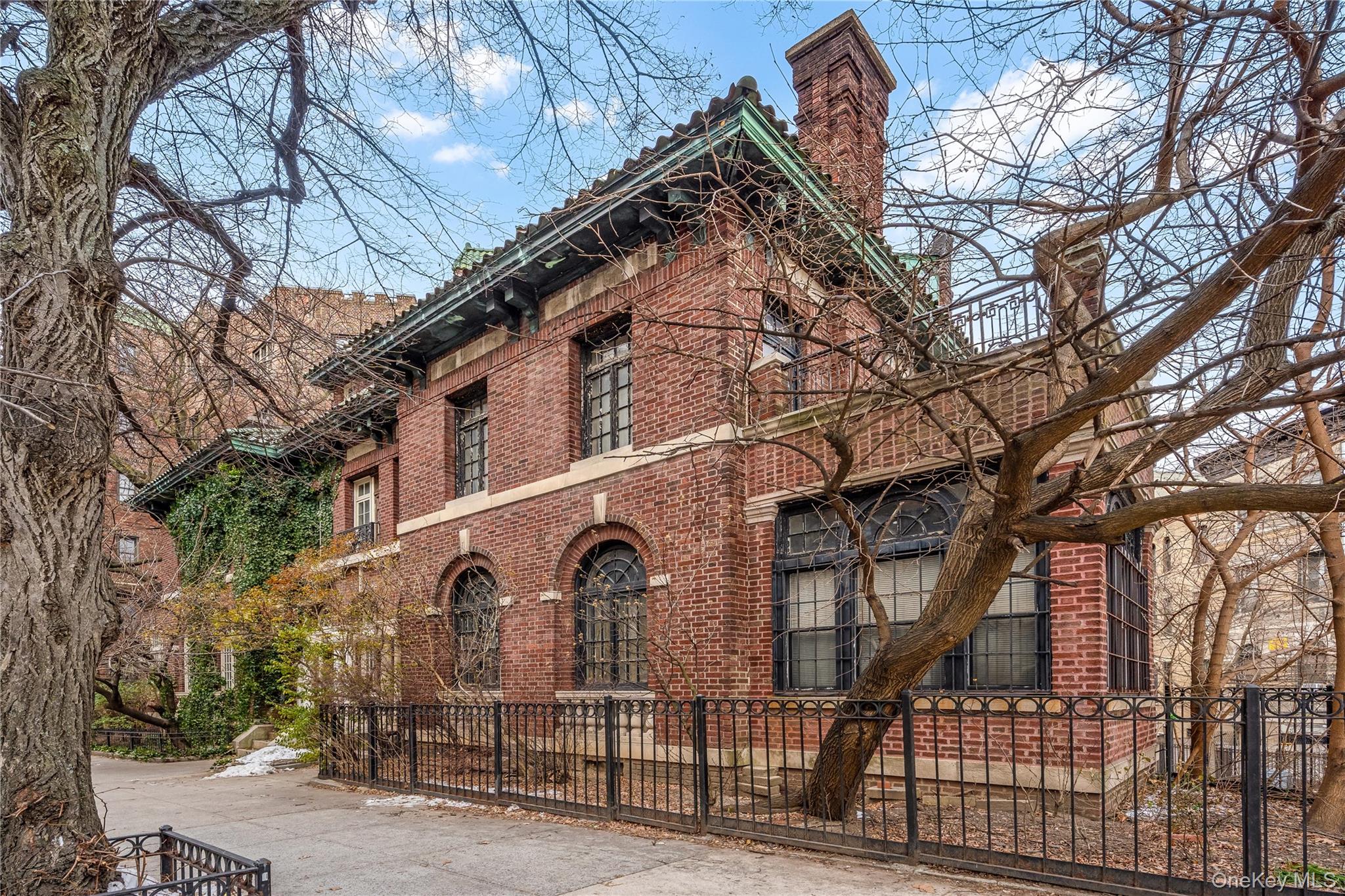 811 Riverside Drive Manhattan, NY 10032 - Photo 5 of 7 a view of a large house with a large tree