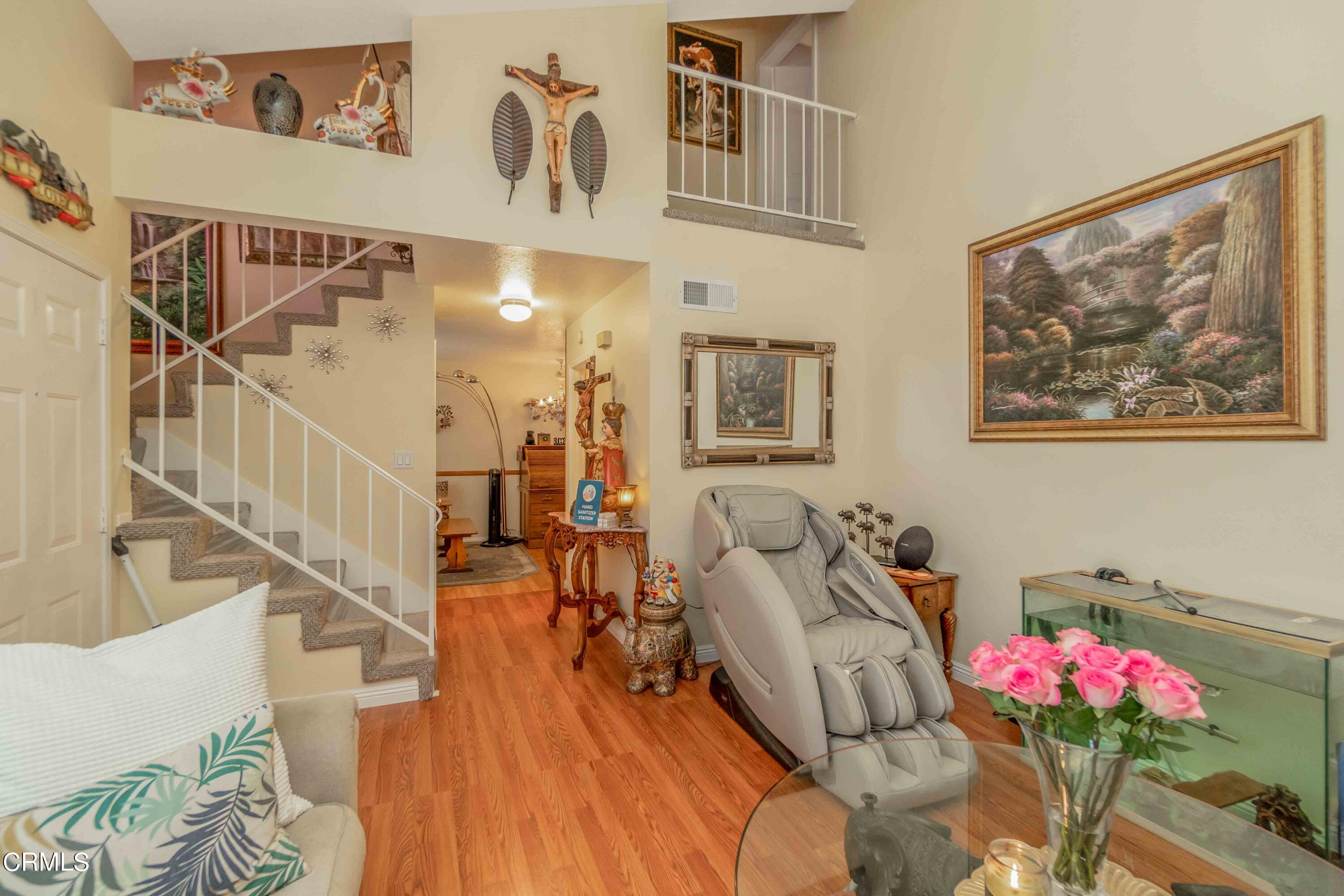 432 Johnson Road Oxnard, CA 93033 - Photo 19 of 40 a living room with furniture stairs and a potted plant