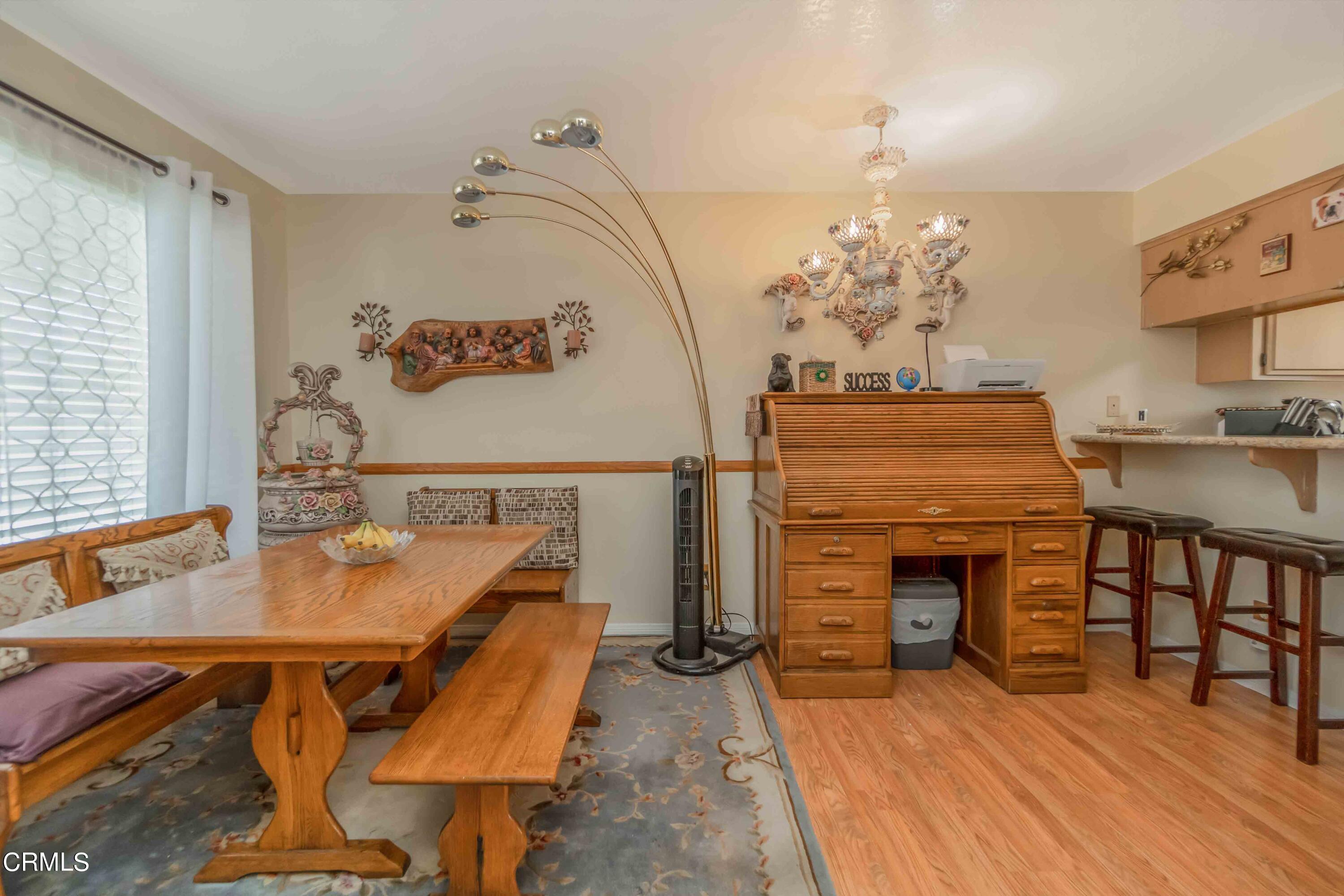 432 Johnson Road Oxnard, CA 93033 - Photo 23 of 40 a dining room with furniture a chandelier and wooden floor