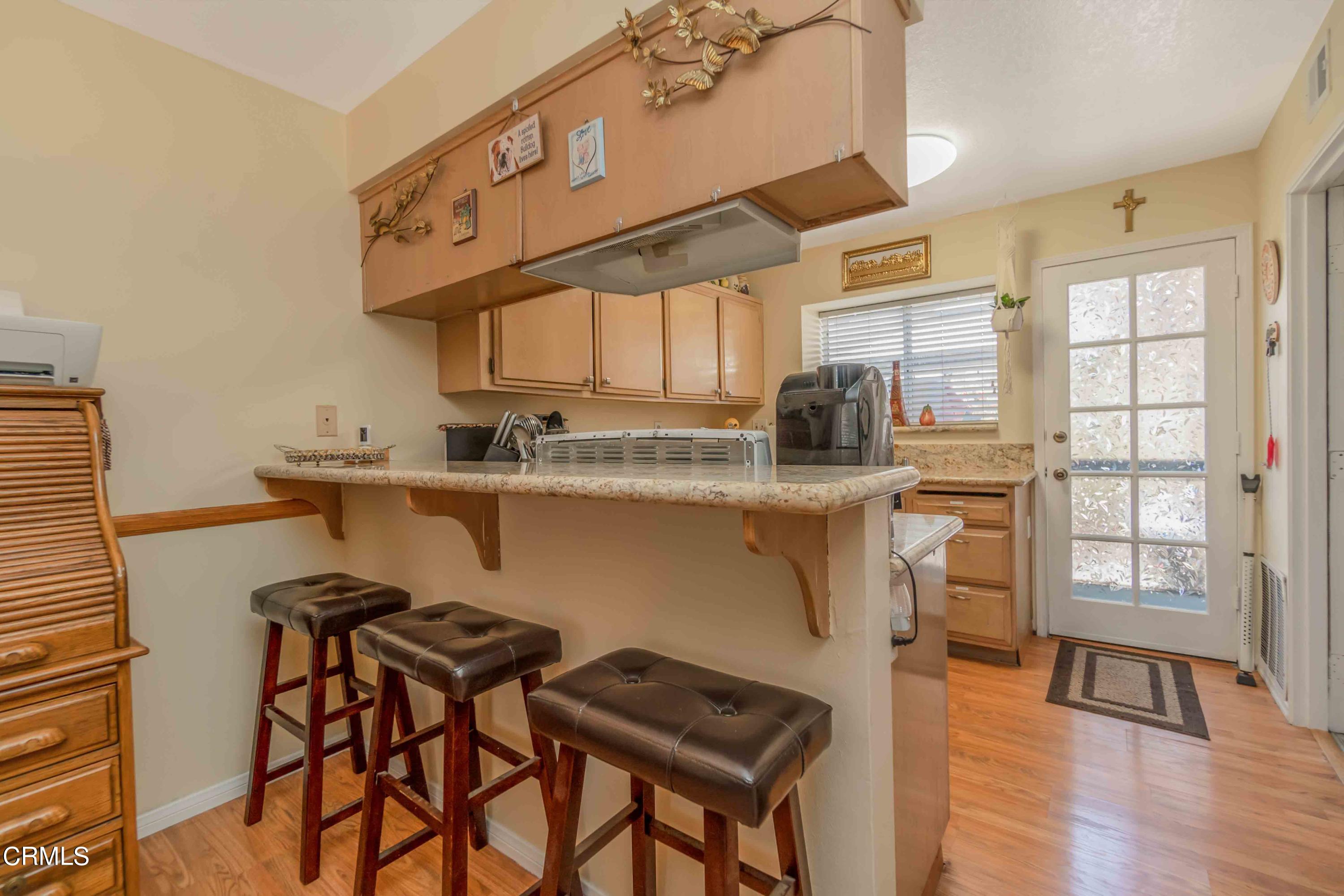 432 Johnson Road Oxnard, CA 93033 - Photo 28 of 40 a kitchen with stainless steel appliances granite countertop a stove a sink dishwasher and cabinets with wooden floor