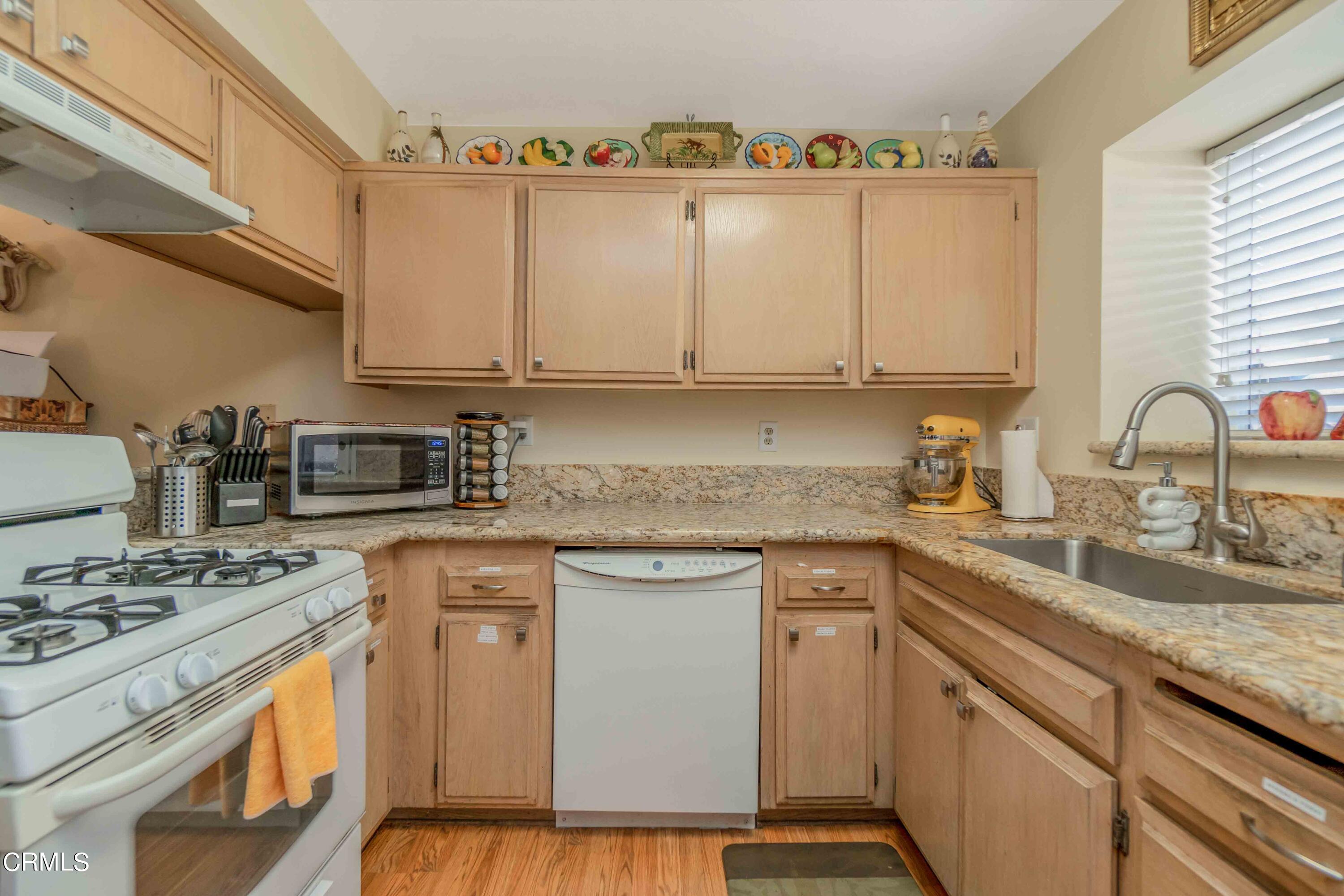 432 Johnson Road Oxnard, CA 93033 - Photo 29 of 40 a kitchen with granite countertop a sink stove and cabinets