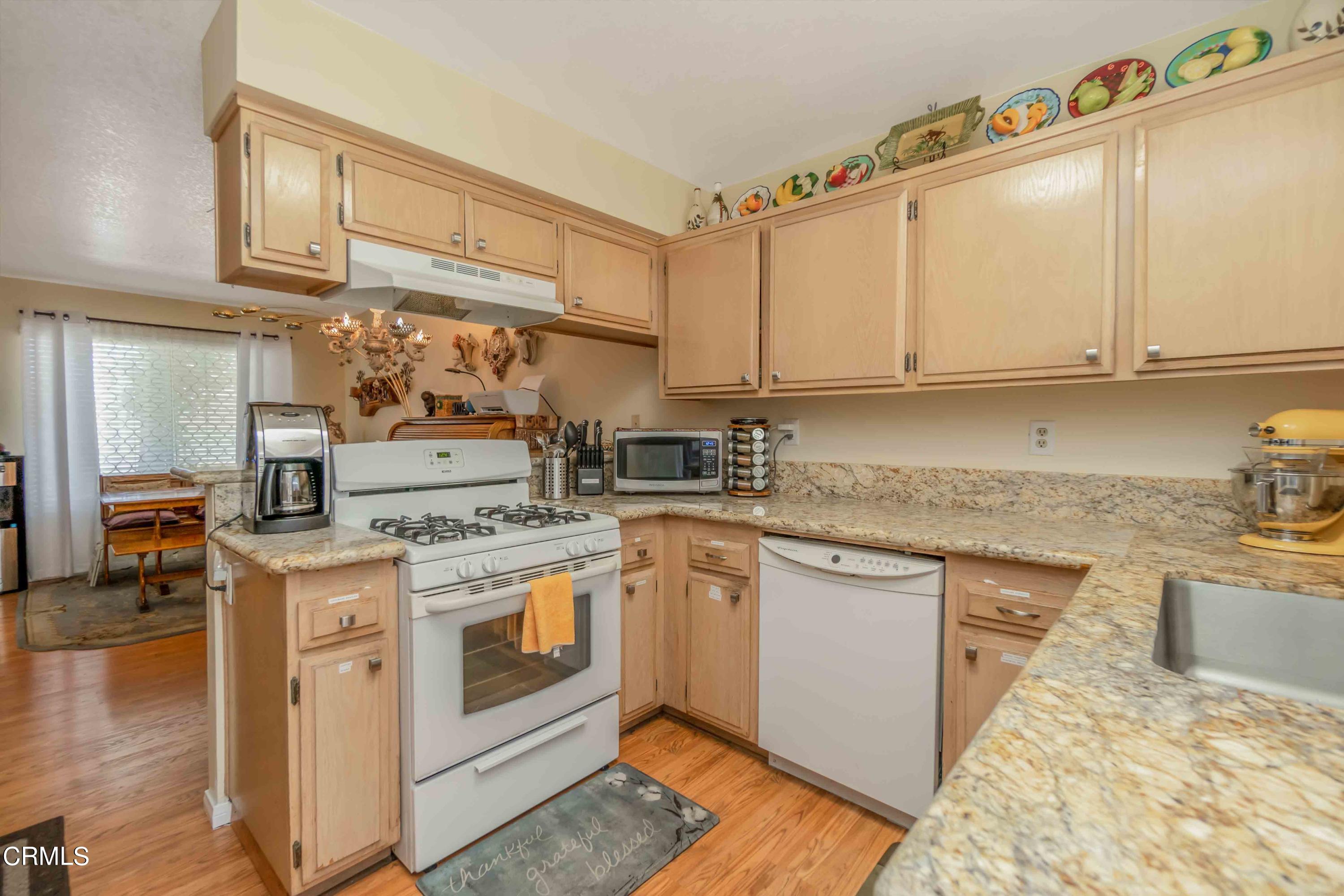 432 Johnson Road Oxnard, CA 93033 - Photo 30 of 40 a kitchen with stainless steel appliances granite countertop a stove and white cabinets
