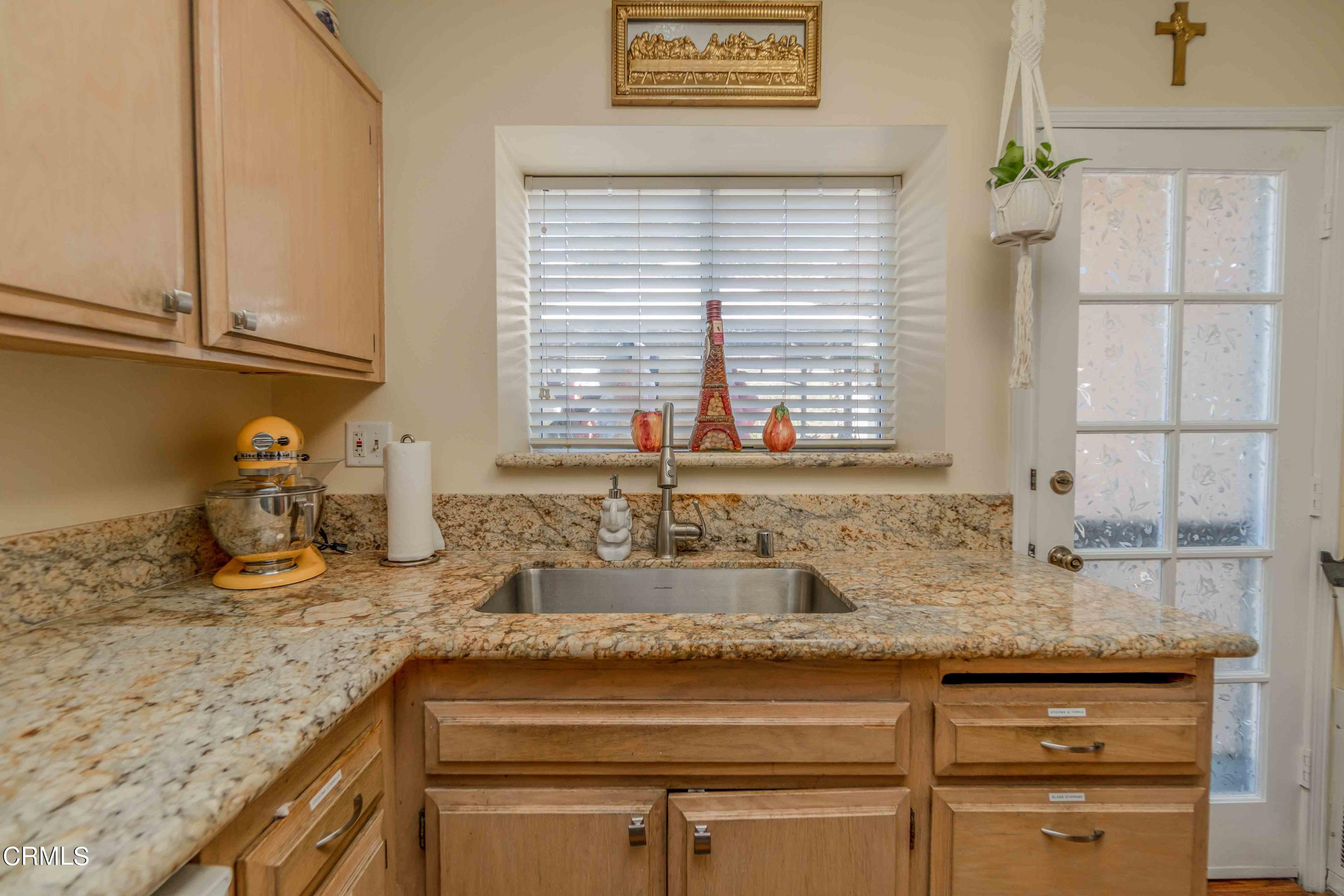 432 Johnson Road Oxnard, CA 93033 - Photo 31 of 40 a kitchen with granite countertop sink and cabinets