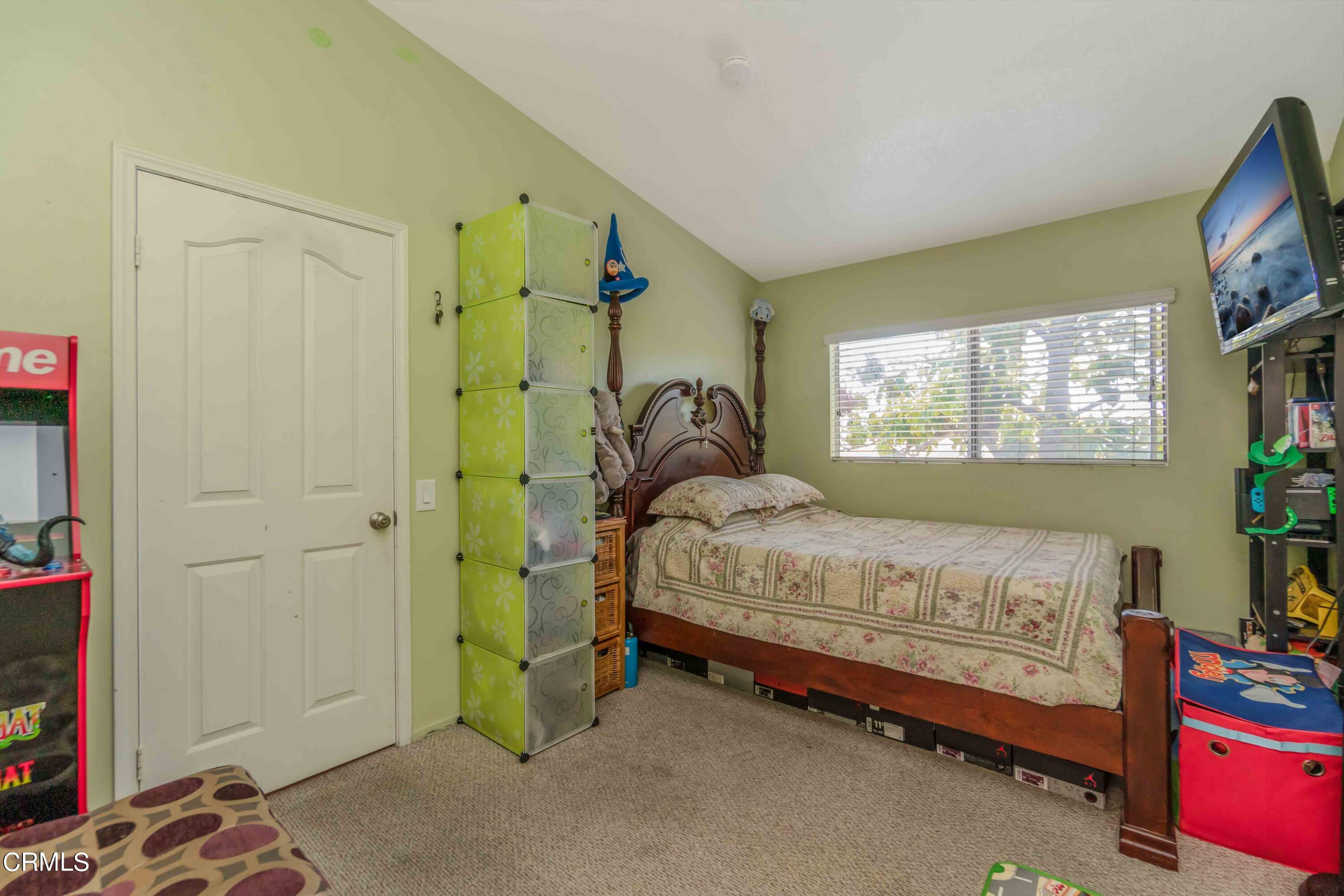 432 Johnson Road Oxnard, CA 93033 - Photo 32 of 40 a bedroom with a bed and a window