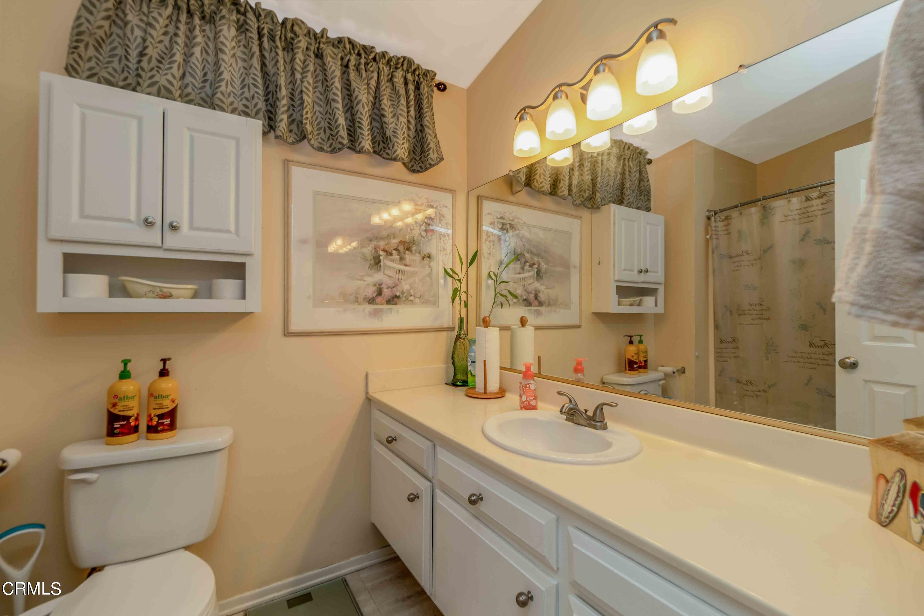 432 Johnson Road Oxnard, CA 93033 - Photo 39 of 40 a bathroom with a granite countertop sink mirror vanity and toilet
