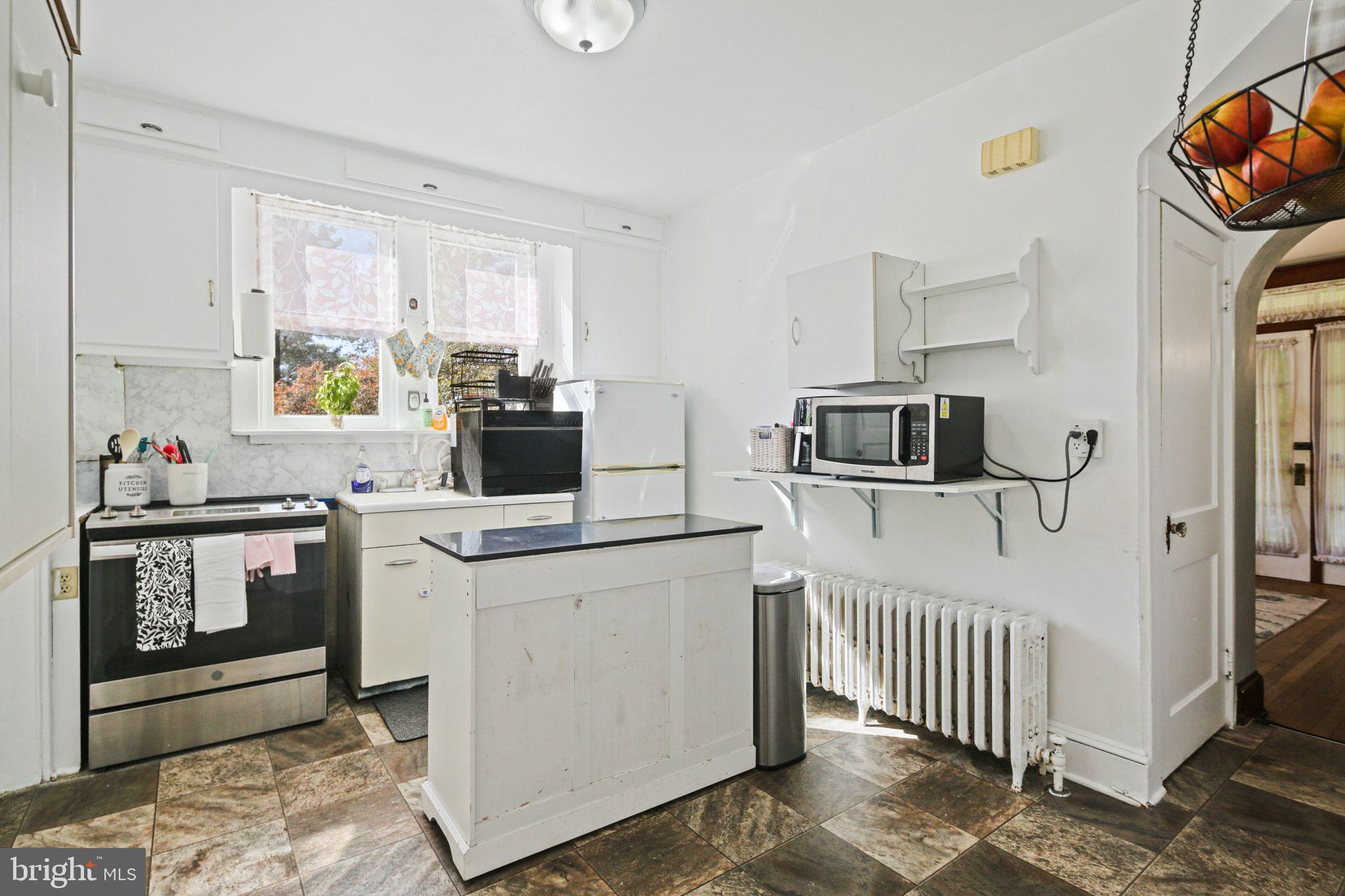 5713 Old Court Road Windsor Mill, MD 21244 - Photo 12 of 31 a kitchen with stainless steel appliances granite countertop a stove a sink and a microwave