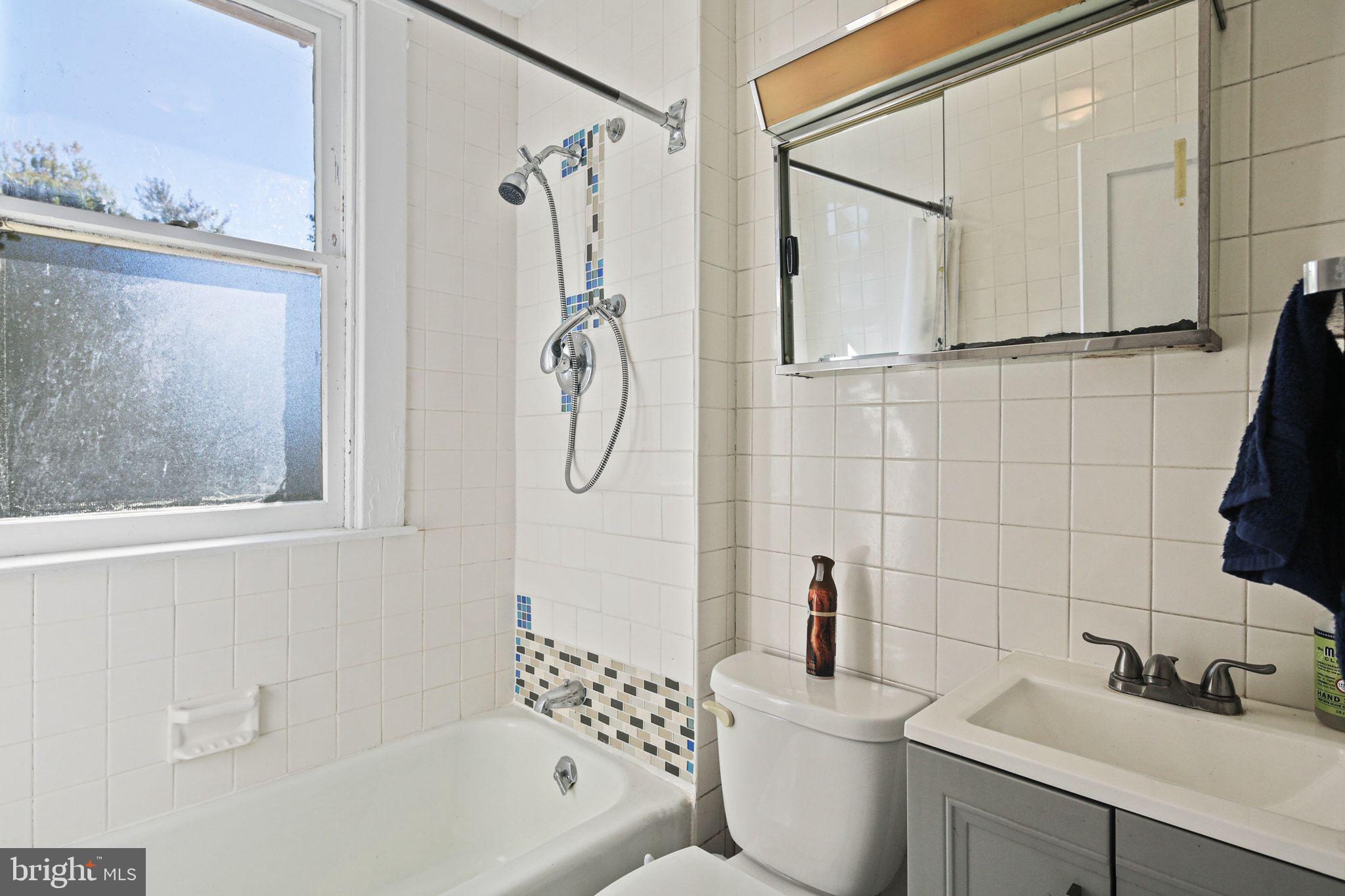 5713 Old Court Road Windsor Mill, MD 21244 - Photo 16 of 31 a bathroom with a sink a toilet and shower