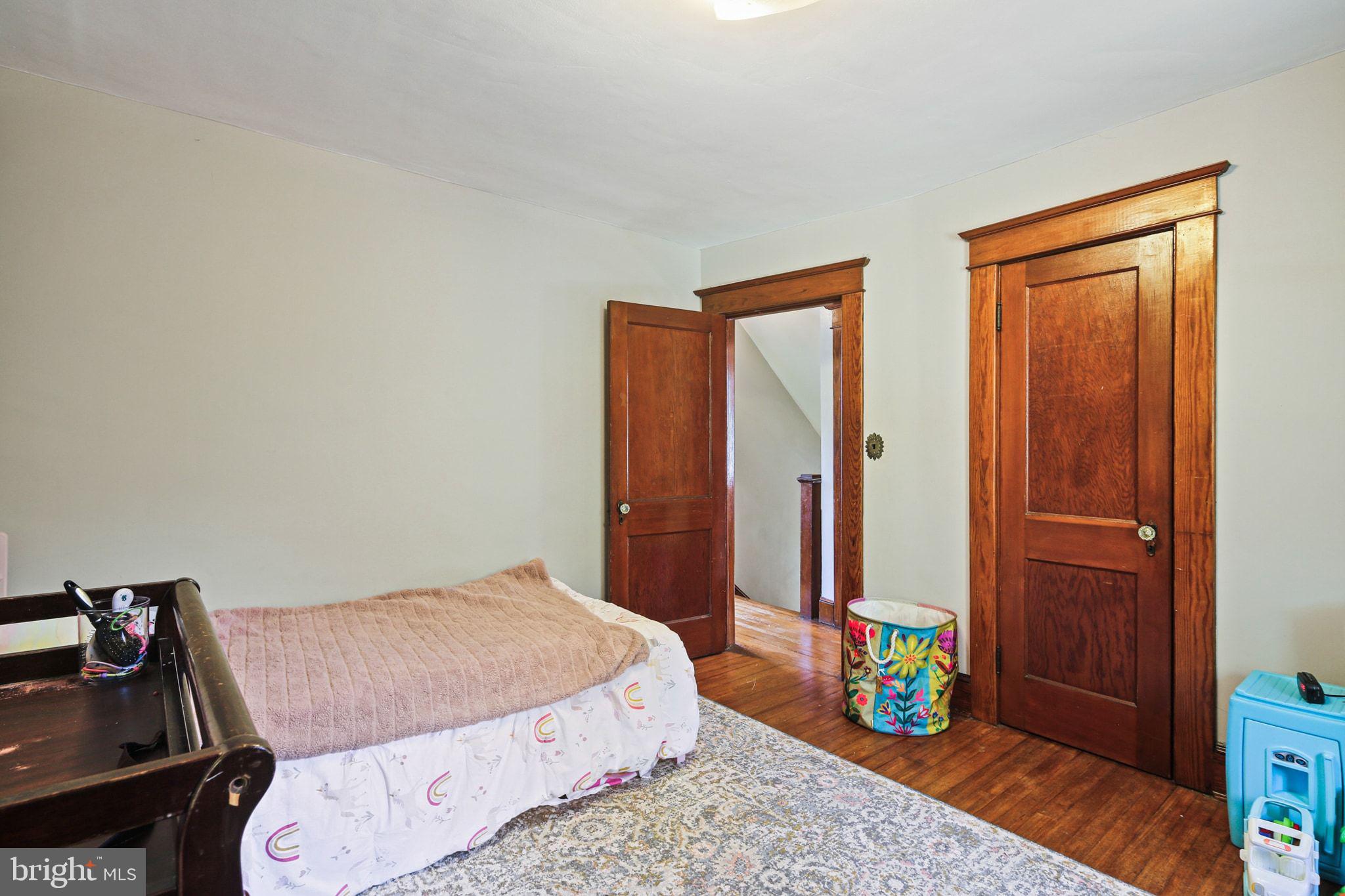 5713 Old Court Road Windsor Mill, MD 21244 - Photo 22 of 31 a bedroom with a bed a dresser and a window