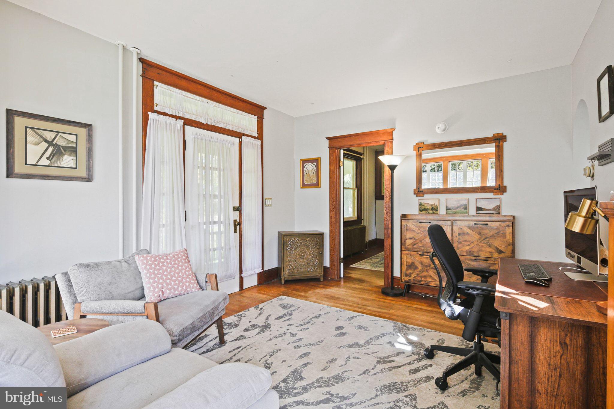 5713 Old Court Road Windsor Mill, MD 21244 - Photo 8 of 31 a living room with furniture a flat screen tv and a window
