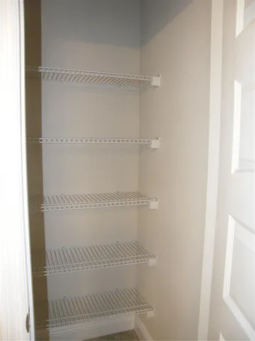 a bedroom with a large bed and a mirror on dresser