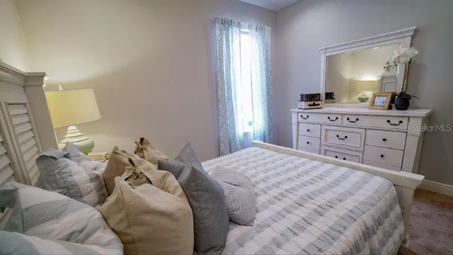a bathroom with a granite countertop toilet sink and mirror