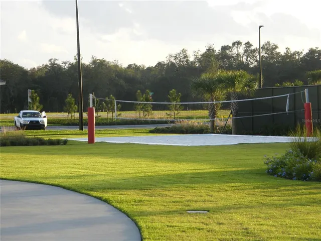 a front view of a house with a tree