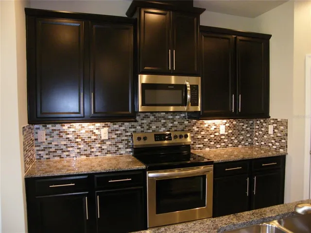 a kitchen with a sink and refrigerator