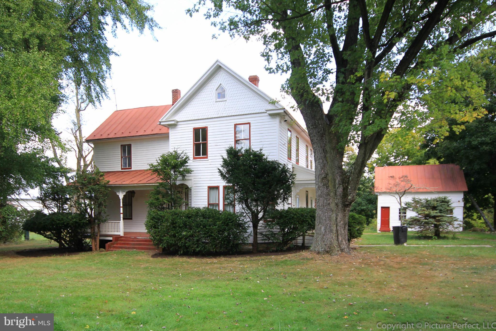 1801 Long Corner Road Mount Airy, MD 21771 - Photo 1 of 30 a front view of a house with a yard and trees