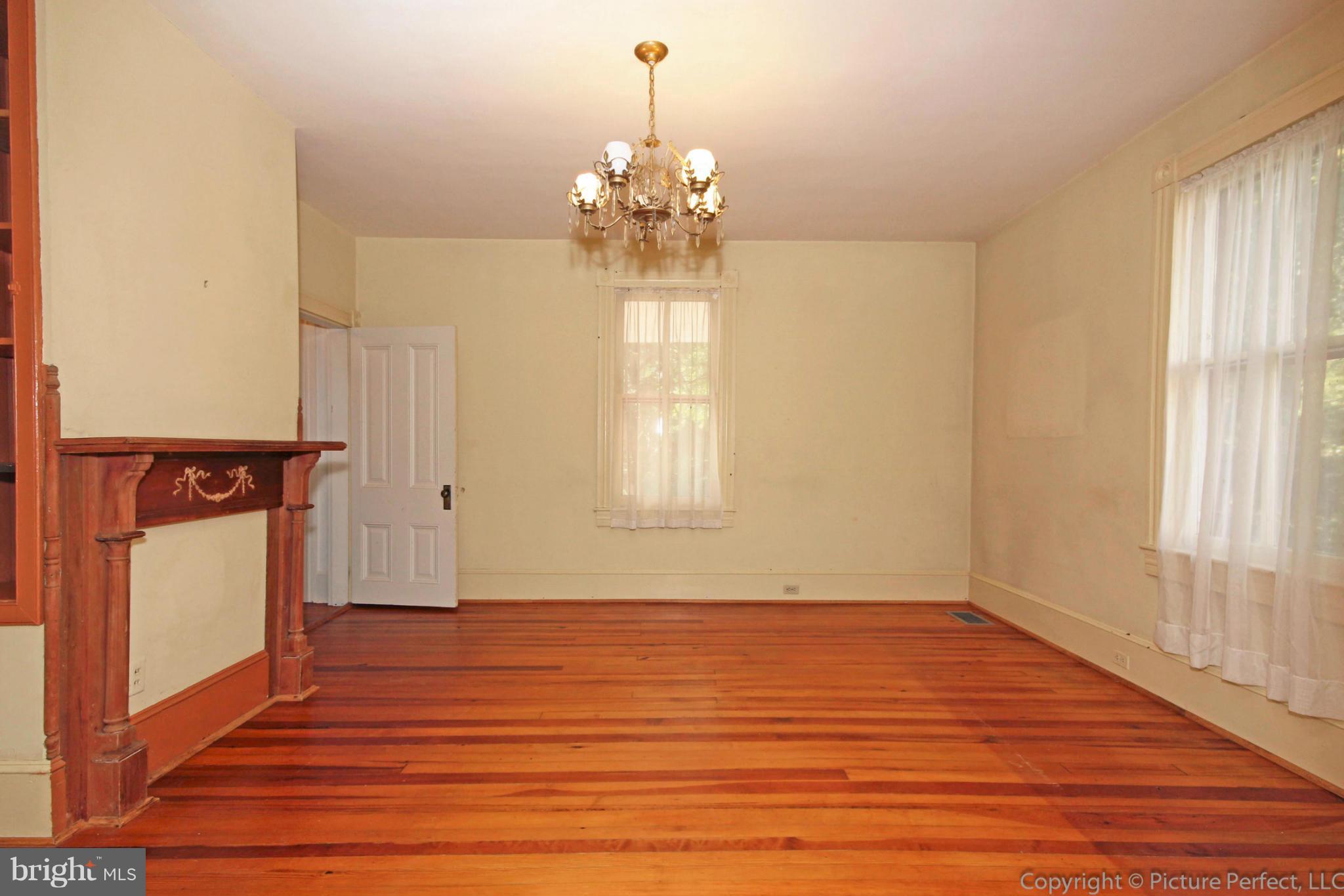1801 Long Corner Road Mount Airy, MD 21771 - Photo 12 of 30 a view of an empty room with wooden floor and a window