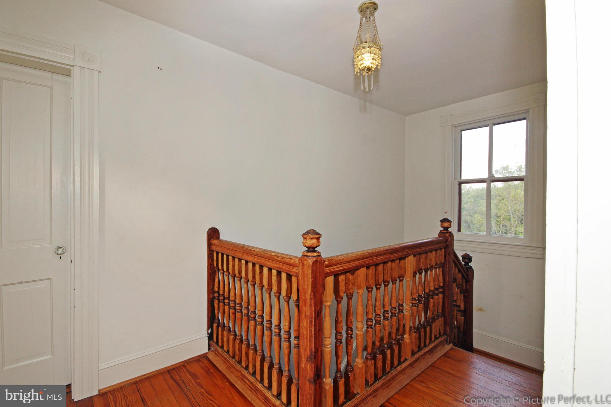 1801 Long Corner Road Mount Airy, MD 21771 - Photo 16 of 30 a view of a hallway with wooden floor and stairs
