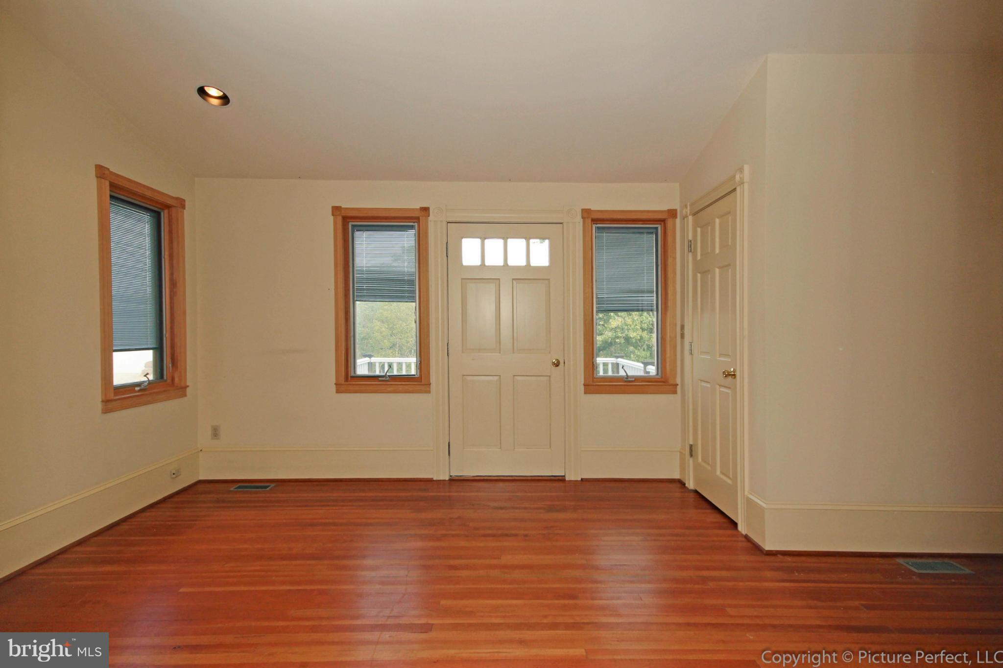 1801 Long Corner Road Mount Airy, MD 21771 - Photo 17 of 30 a view of an empty room with wooden floor and a window