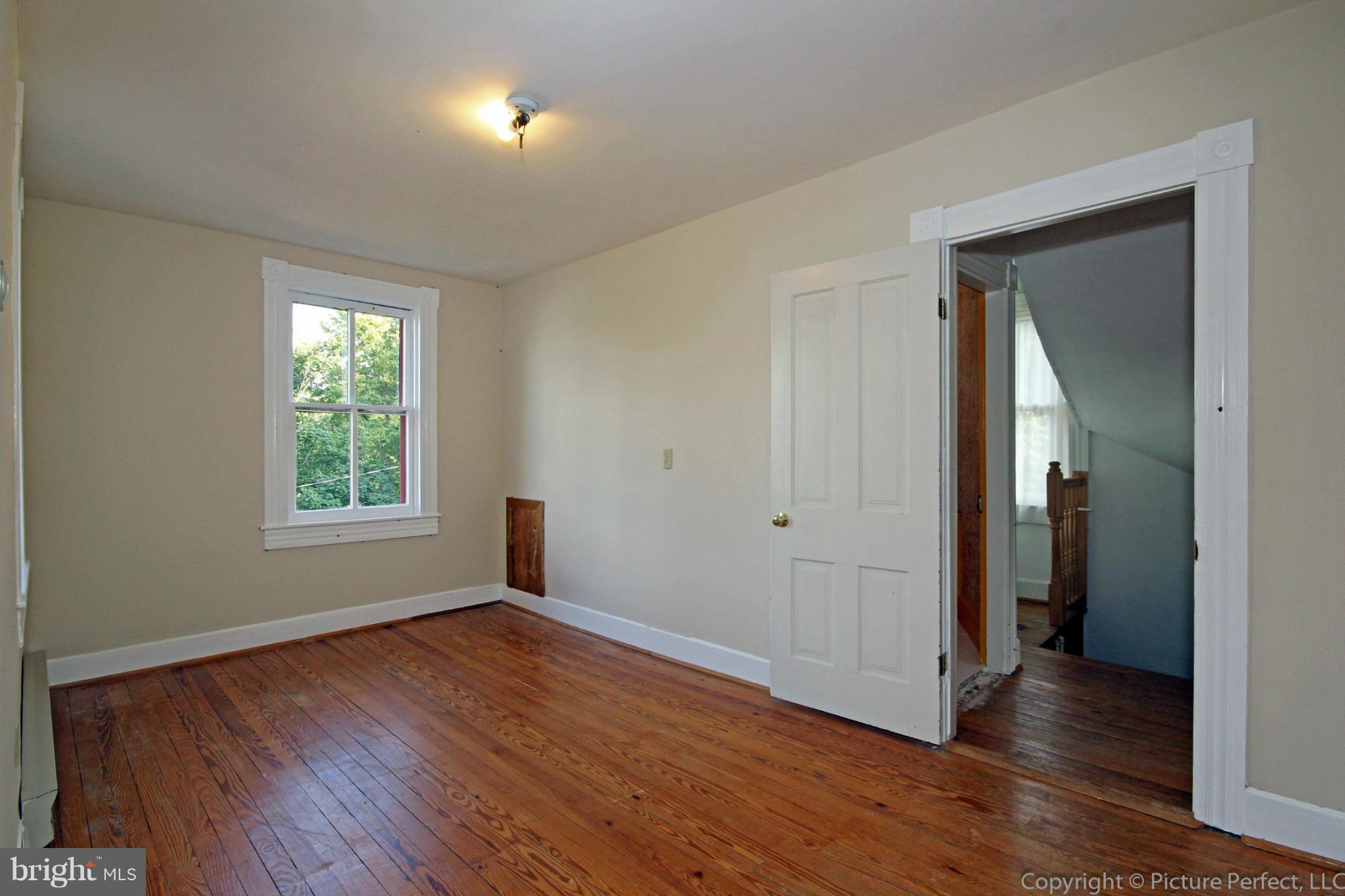 1801 Long Corner Road Mount Airy, MD 21771 - Photo 20 of 30 a view of an empty room with wooden floor and a window
