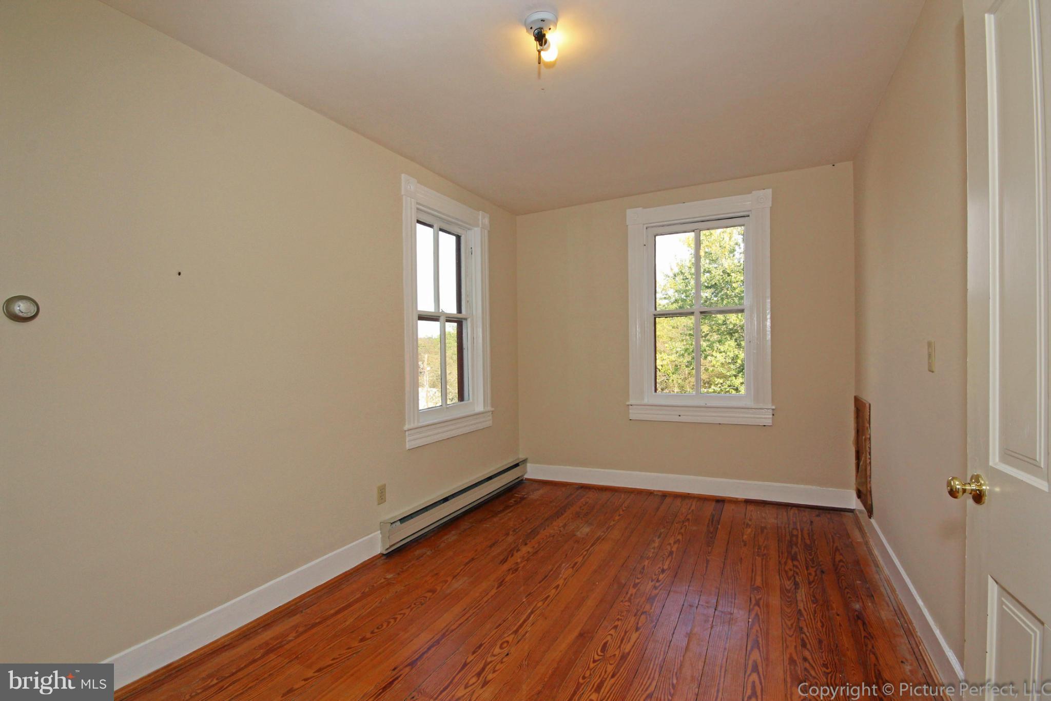 1801 Long Corner Road Mount Airy, MD 21771 - Photo 21 of 30 an empty room with wooden floor and windows