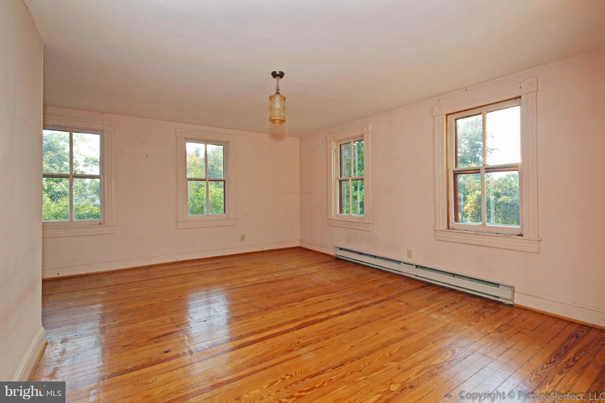 1801 Long Corner Road Mount Airy, MD 21771 - Photo 23 of 30 an empty room with wooden floor and windows