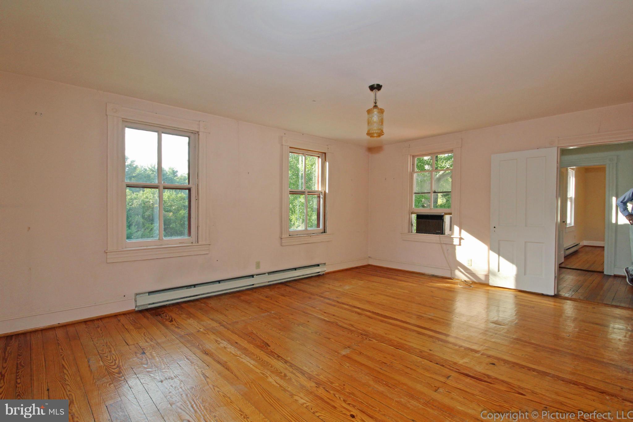 1801 Long Corner Road Mount Airy, MD 21771 - Photo 24 of 30 a view of an empty room with window and wooden floor