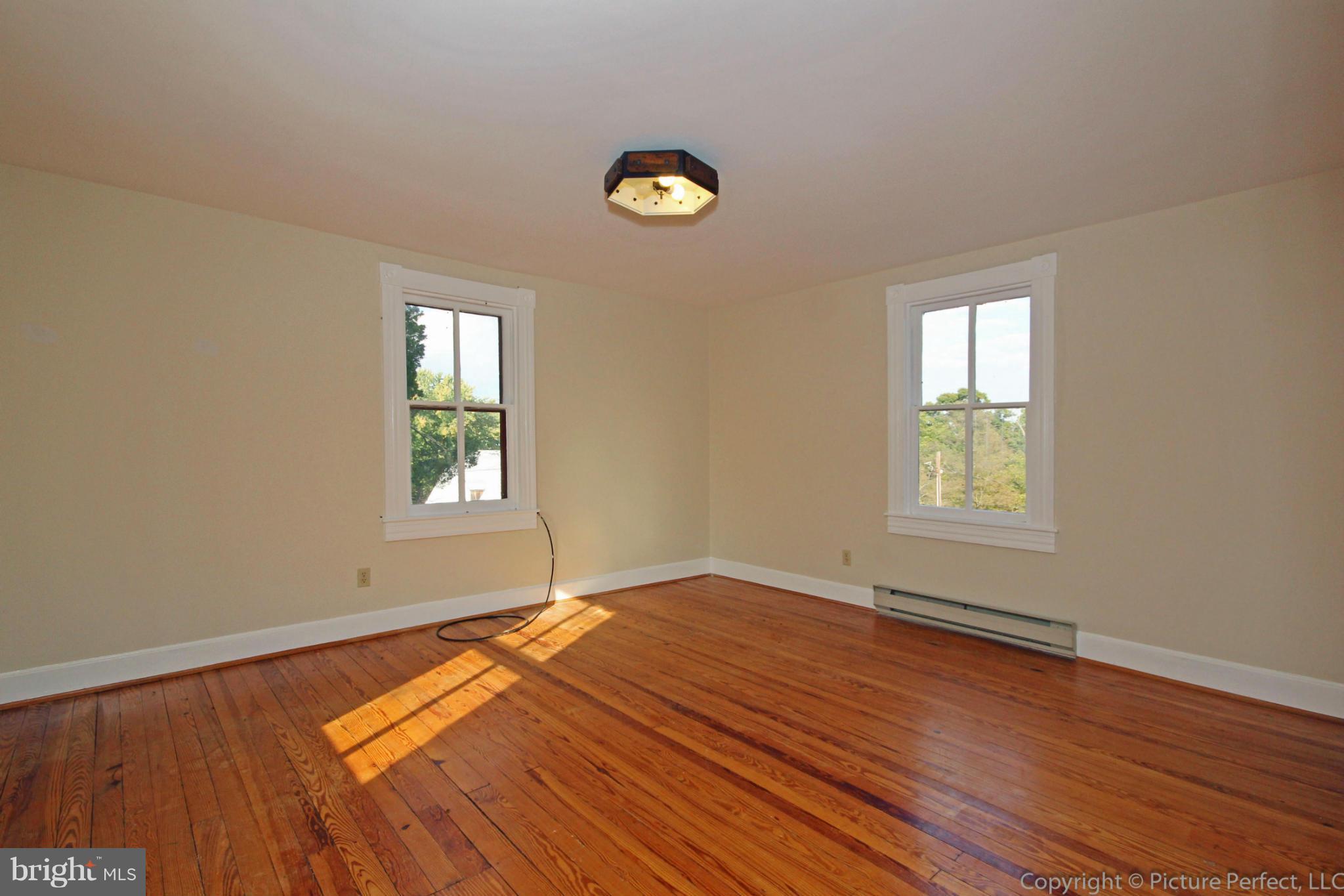 1801 Long Corner Road Mount Airy, MD 21771 - Photo 25 of 30 a view of empty room with window and wooden floor