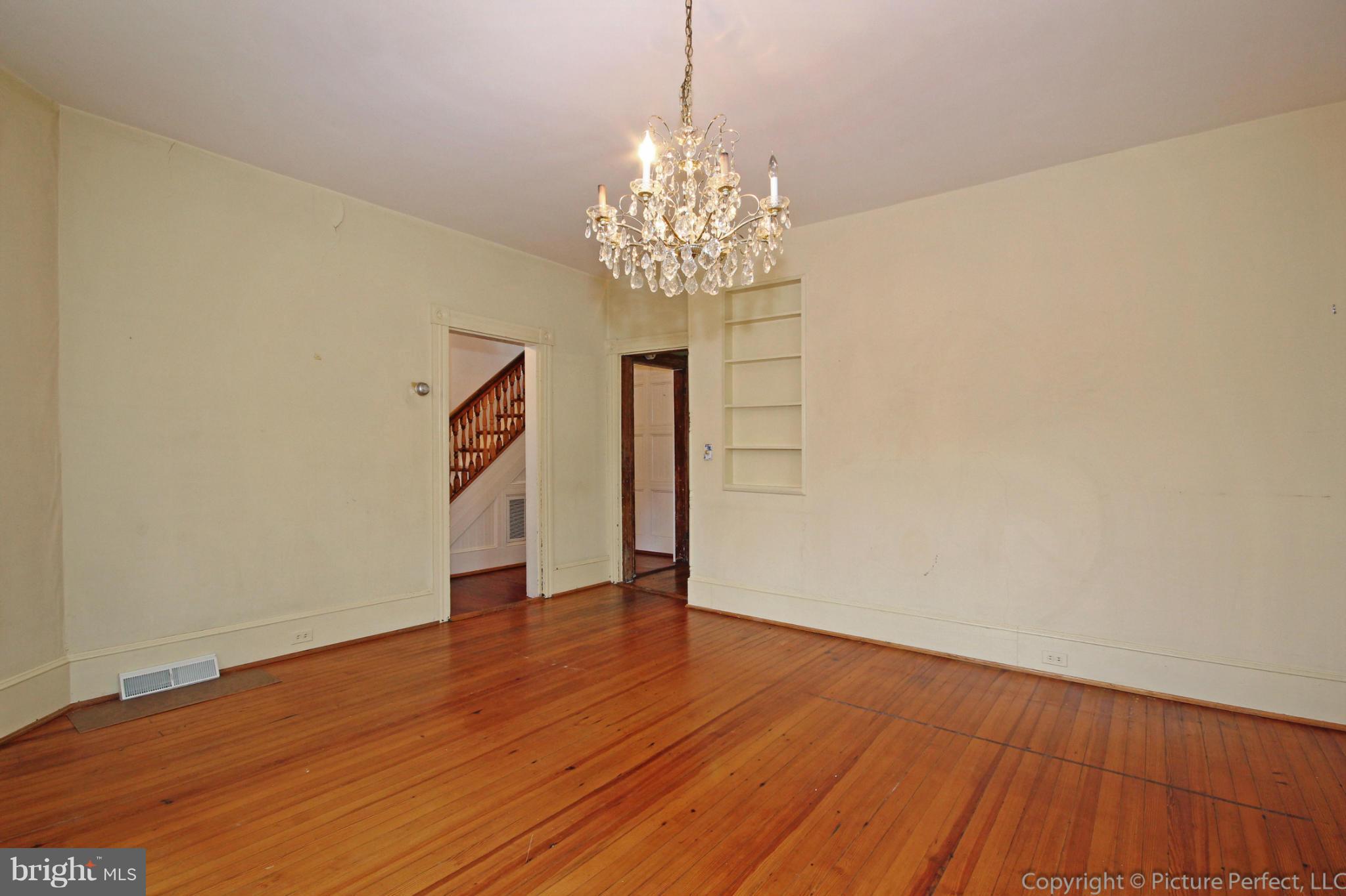 1801 Long Corner Road Mount Airy, MD 21771 - Photo 9 of 30 a view of an empty room with wooden floor and a chandelier