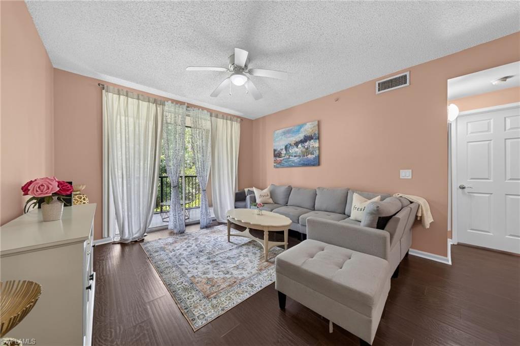 1105 Reserve Court, Unit 206 Naples, FL 34105 - Photo 1 of 23 a living room with furniture and a large window