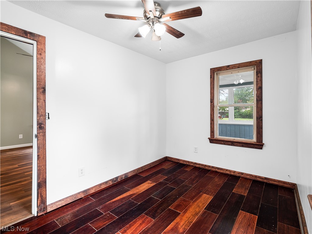339 Cummings Road Vermilion, OH 44089 - Photo 27 of 35 Unfurnished room with ceiling fan and dark hardwood flooring