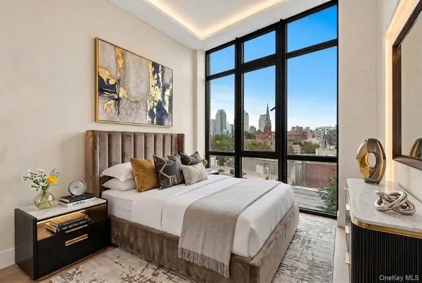 a bedroom with large windows and a chandelier