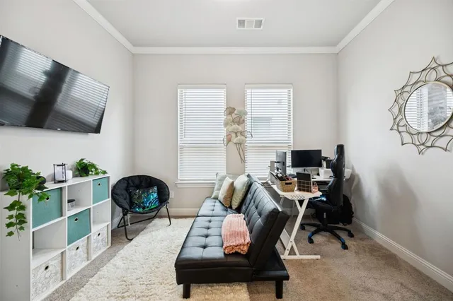 a view of a workspace with furniture and a window