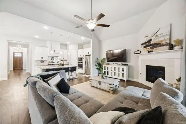 a living room with furniture kitchen view and a fireplace