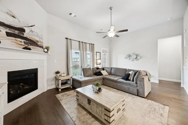 a living room with furniture a fireplace and a chandelier