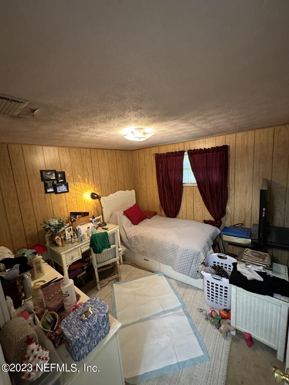 4479 Vinton Road Jacksonville, FL 32207 - Photo 21 of 45 a room with furniture a flat screen tv and a table