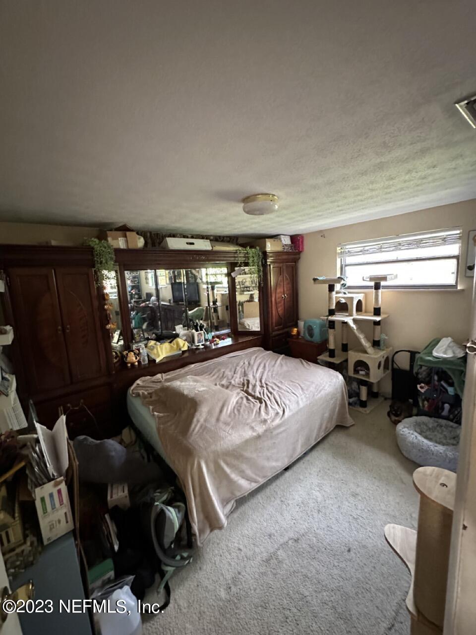 4479 Vinton Road Jacksonville, FL 32207 - Photo 23 of 45 a bed room with furniture and a window