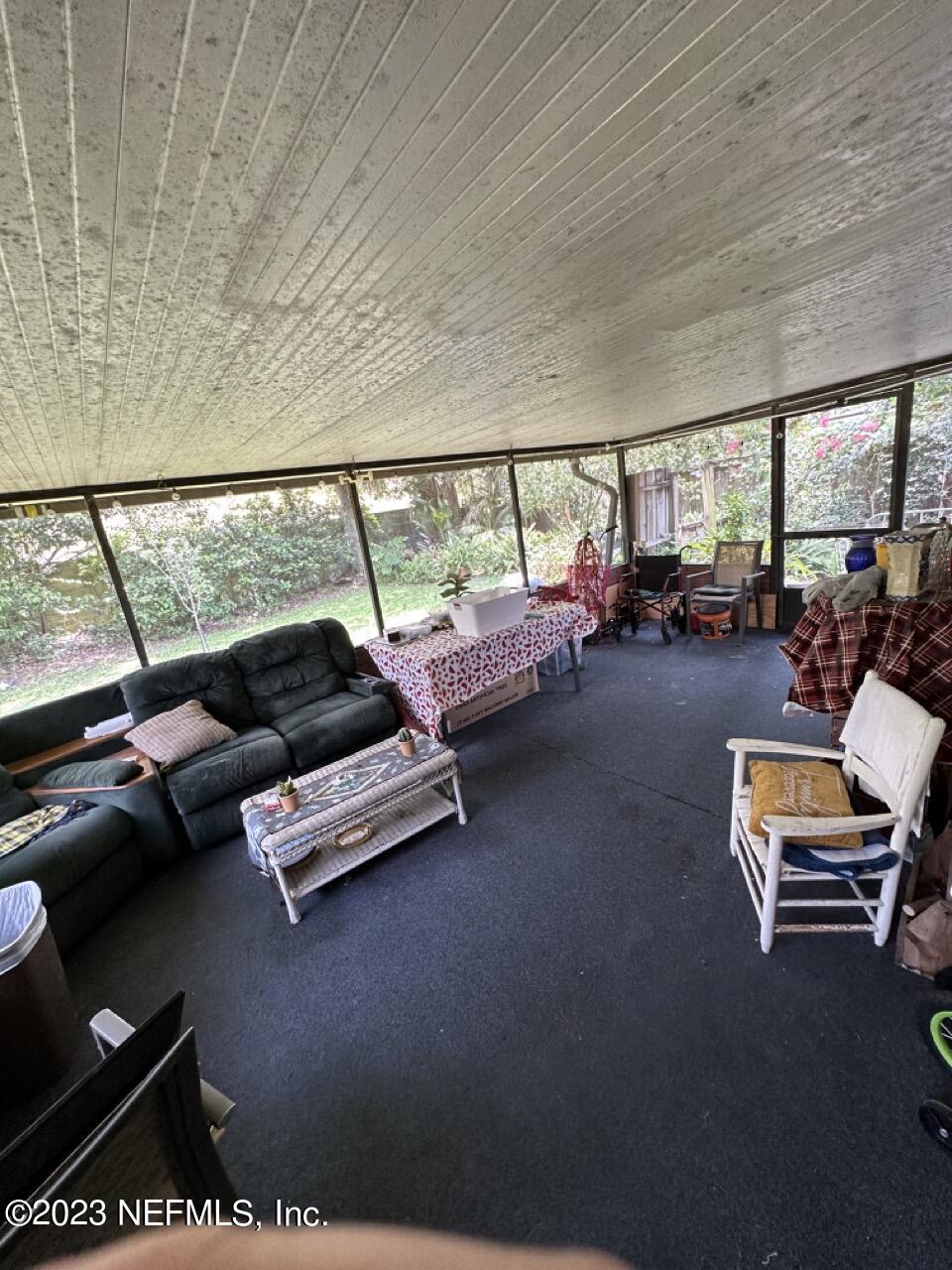 4479 Vinton Road Jacksonville, FL 32207 - Photo 31 of 45 a living room with furniture and a floor to ceiling window