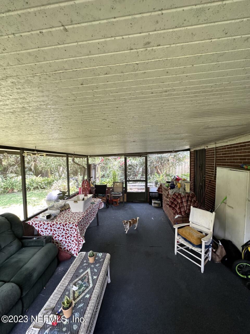 4479 Vinton Road Jacksonville, FL 32207 - Photo 33 of 45 a living room with furniture and a floor to ceiling window