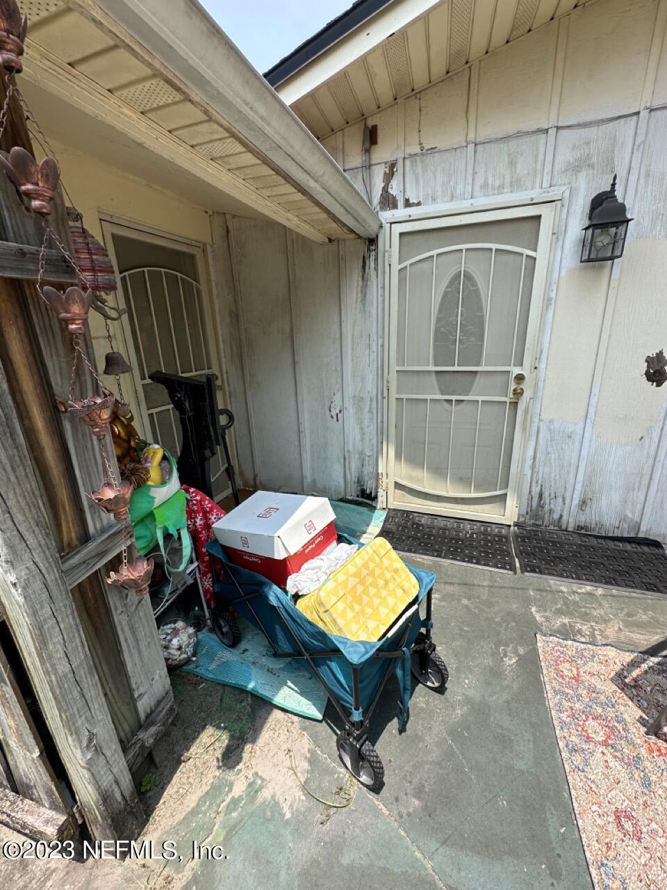 4479 Vinton Road Jacksonville, FL 32207 - Photo 8 of 45 a backyard of a house with barbeque oven table and chairs